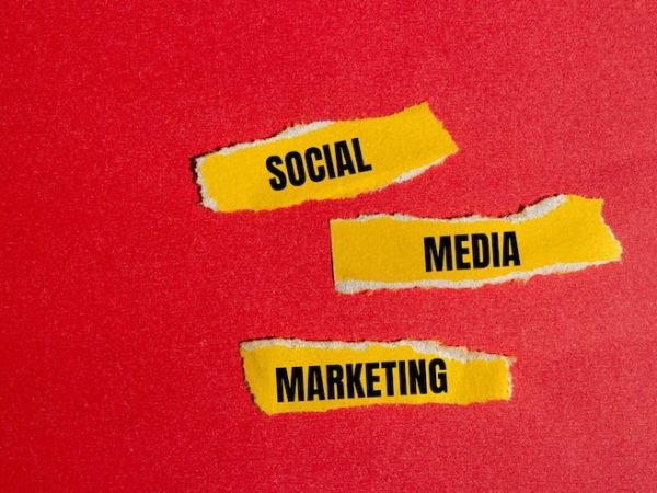 social-media-marketing-words-written-ripped-yellow-paper-pieces-with-red-background_648871-5894
